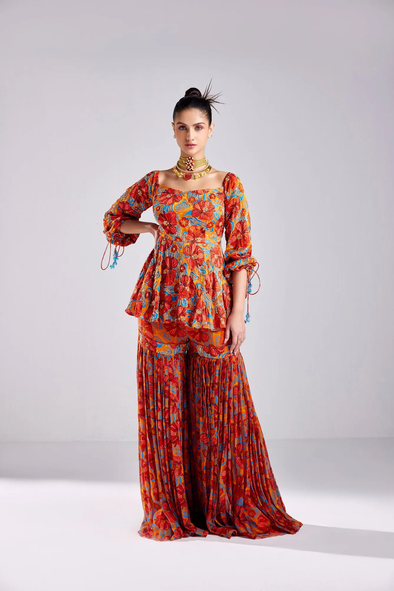 RUST FLORAL WAVE PRINT PEPLUM WITH RUST FLORAL WAVE PRINTED GHARARA PANTS