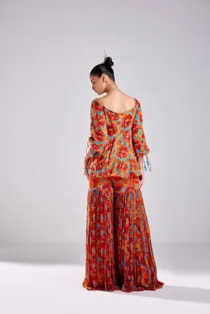 RUST FLORAL WAVE PRINT PEPLUM WITH RUST FLORAL WAVE PRINTED GHARARA PANTS